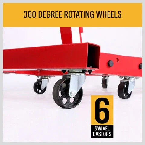 Close-up of six black swivel caster wheels on red metal frame with 360 degree rotation feature