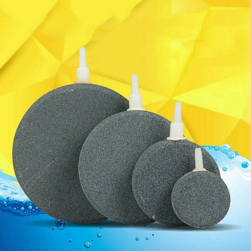 Round aquarium air stones of various sizes with plastic connectors on colorful background