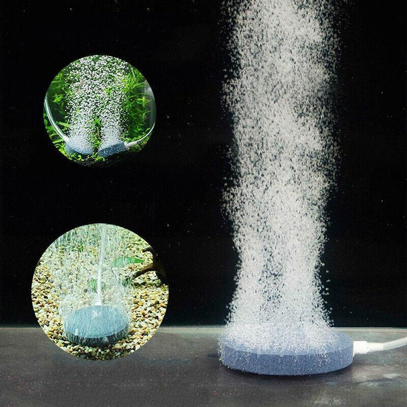 Round aquarium air stone disk releasing fine bubbles underwater