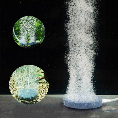 Round aquarium air stone disk releasing fine bubbles underwater