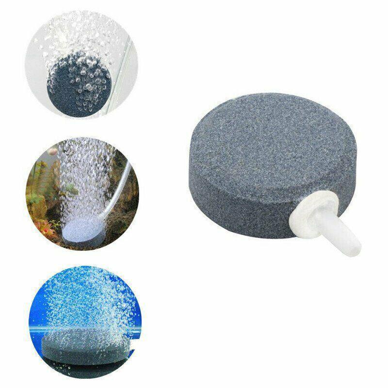 Round aquarium air stone disk with hose connector and bubbles shown in use underwater