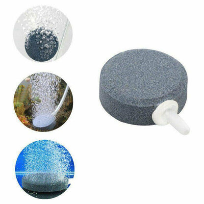Round aquarium air stone disk with hose connector and bubbles shown in use underwater