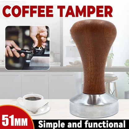 51mm coffee tamper with wooden handle and stainless steel base on kitchen counter with cup of coffee