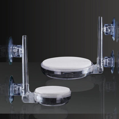 Clear plastic suction cup disk holders with white pads on dark background