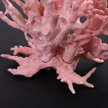 Realistic pink artificial coral reef ornament on a black background, aquarium decor