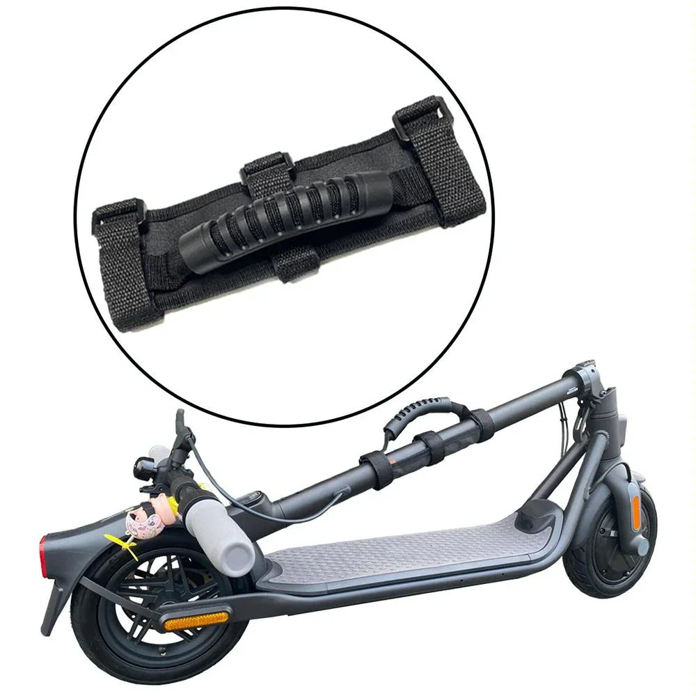 Black portable carrying handle strap attached to a folded electric scooter