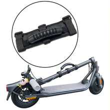 Black portable carrying handle strap attached to a folded electric scooter