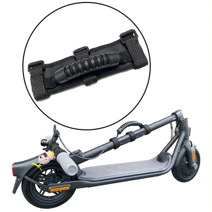 Black portable carrying handle strap attached to a folded electric scooter