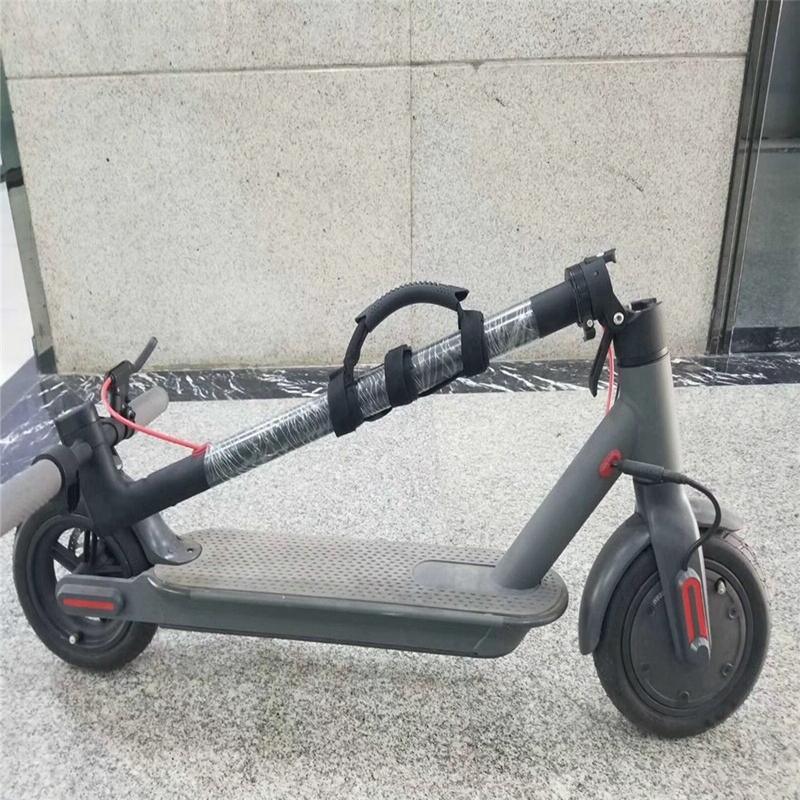Foldable electric scooter with carrying handle on a marble floor, compact urban transport