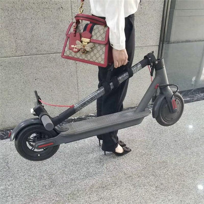 Person holding folded electric scooter indoors, modern portable transport