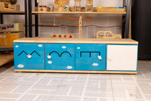 Blue kids storage unit with cloud & mountain designs, wooden top, perfect for toy organization