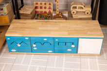 Blue wooden kids storage unit with cloud designs and toy organization drawers