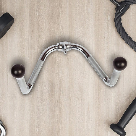 Chrome tricep pushdown attachment with black ball handles on light wood gym floor