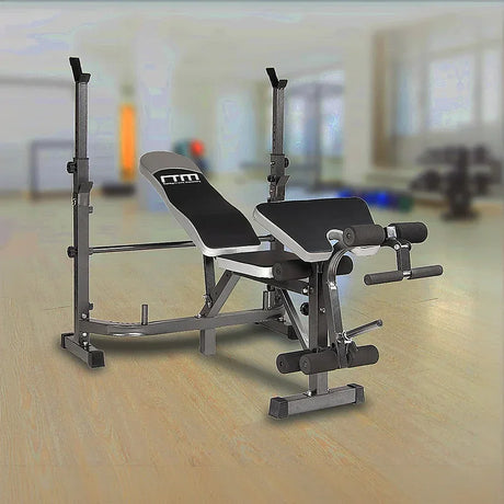 Adjustable weight bench with leg developer in a bright gym, home workout equipment
