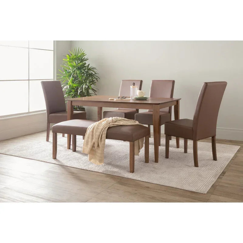 Modern dining room with brown upholstered chairs, wood table, bench, and indoor plant