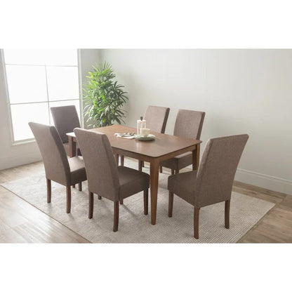 Modern dining room with wooden table, six upholstered chairs and potted plant by window.