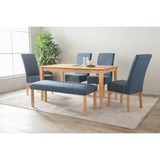 Modern dining table set with blue upholstered chairs and bench on a light rug