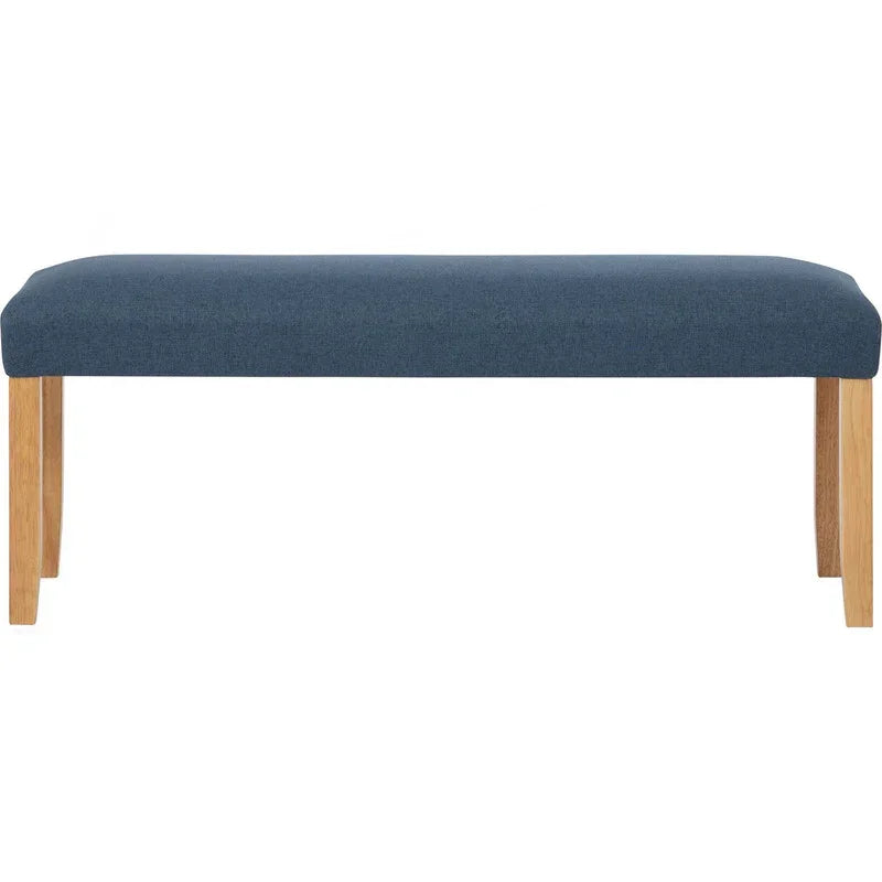 Modern upholstered bench with blue cushion and wooden legs on white background