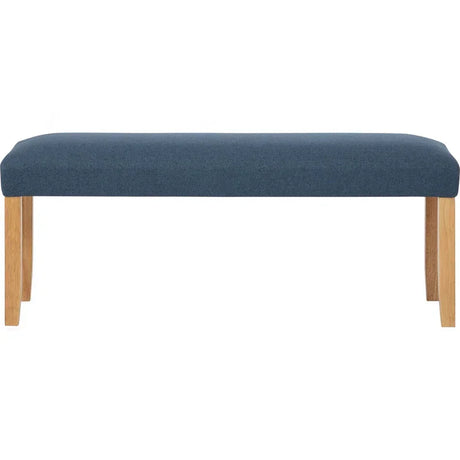 Modern upholstered bench with blue cushion and wooden legs on white background