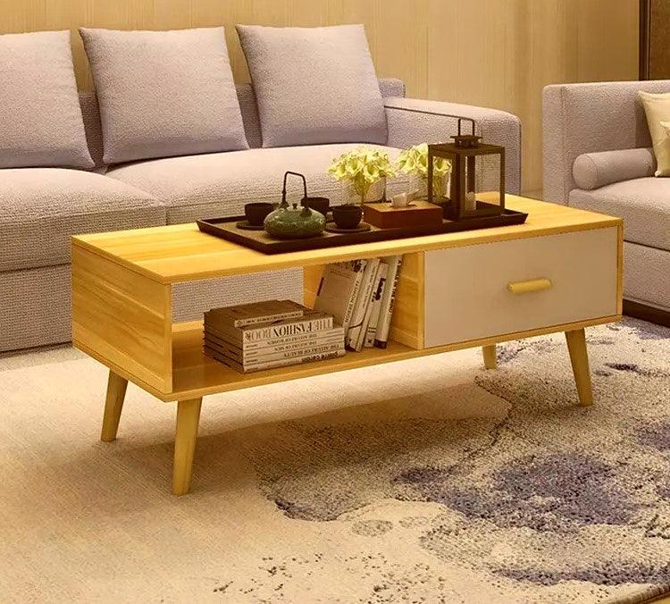 Modern wooden coffee table with decor and books in a cozy living room setting