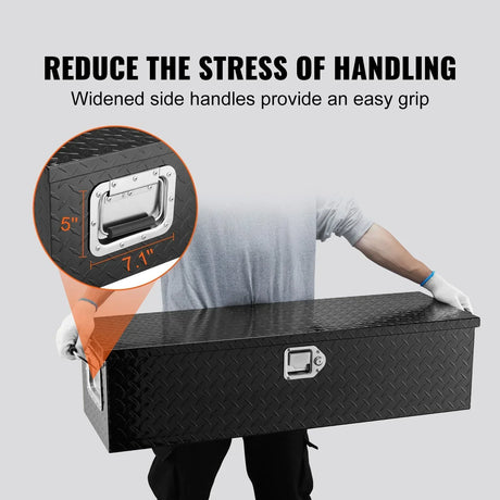 Person holding large black diamond plate toolbox with widened side handles for easy grip