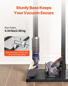 Vacuum stand with sturdy black base on wood floor, digital display shows weight and thickness details.
