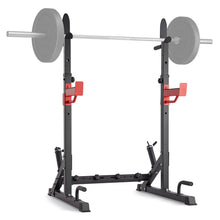 Black squat rack with red safety bars and loaded barbell for home gym workouts