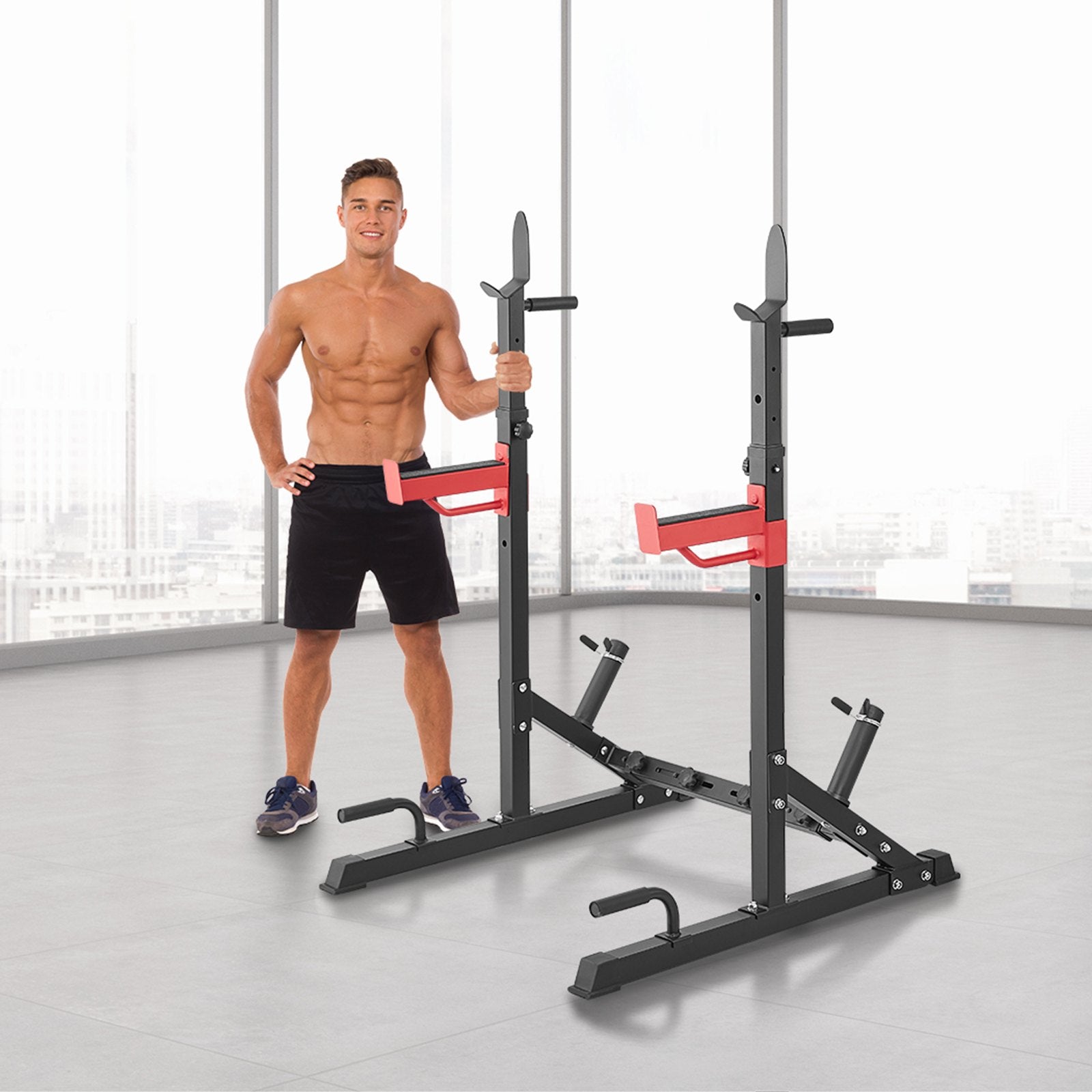 Man posing with black and red squat rack in bright gym, home workout equipment for strength training