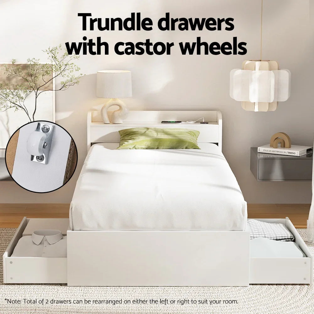 White modern single bed with green pillow and trundle drawers with castor wheels in bright bedroom