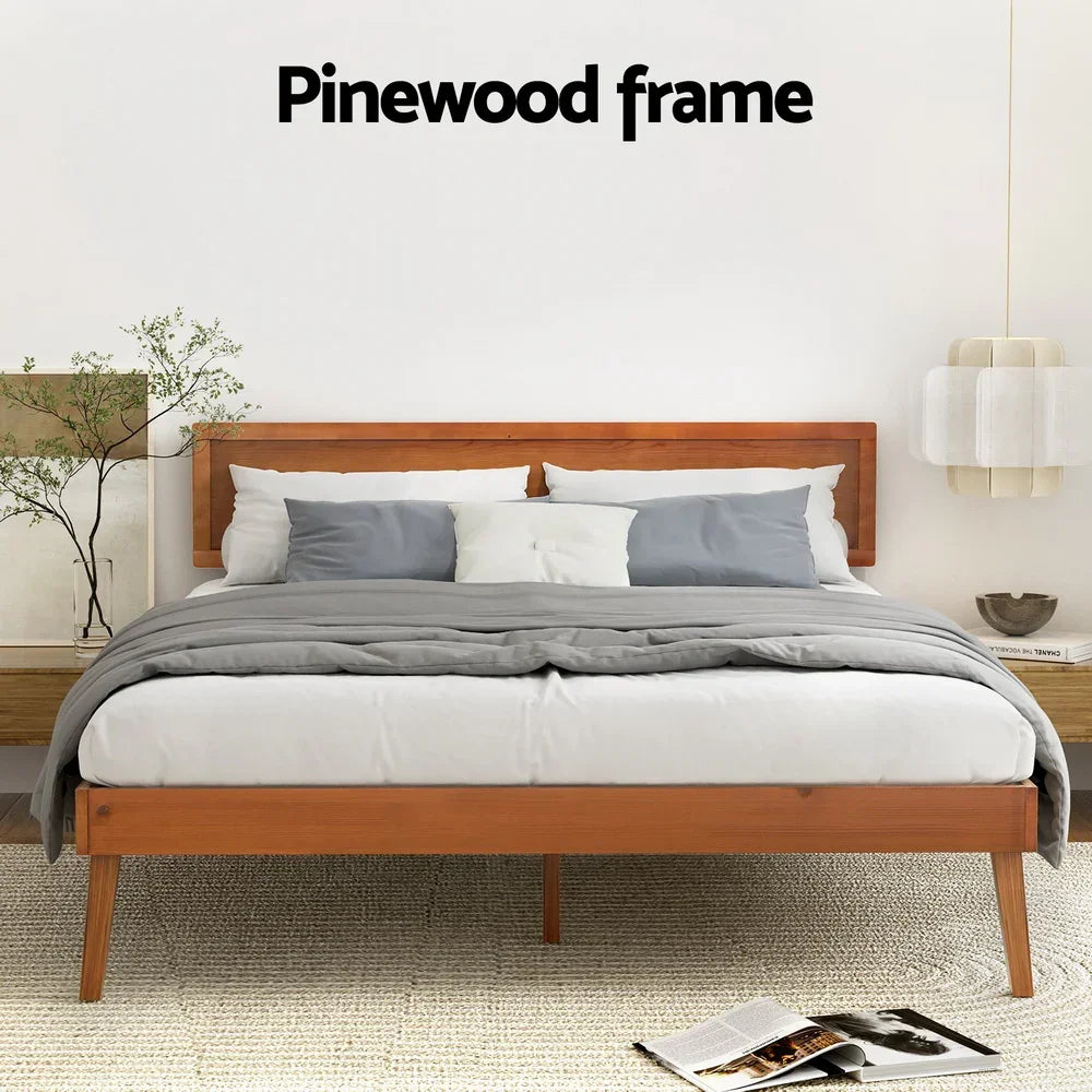 Modern bed with pinewood frame, gray bedding, white and gray pillows in minimalist bedroom