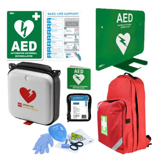 AED defibrillator kit with carry bag, wall signs, gloves, and first aid supplies