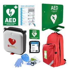 AED defibrillator kit with carry bag, wall signs, gloves, and first aid supplies